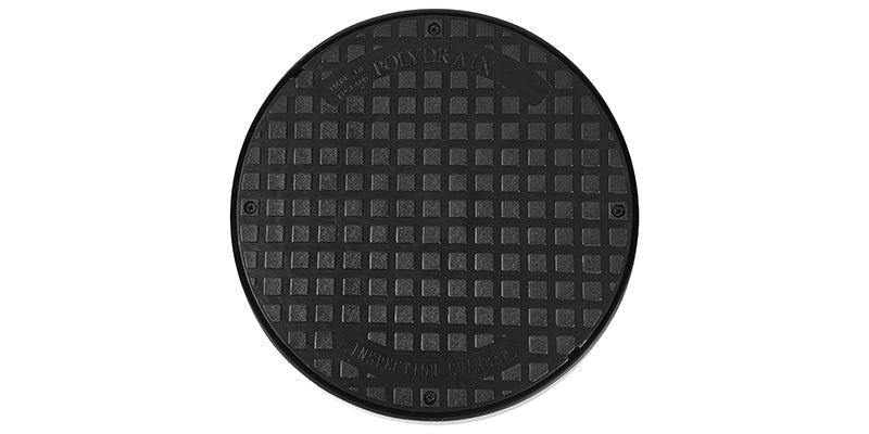 Black manhole cover with textured surface on a white background