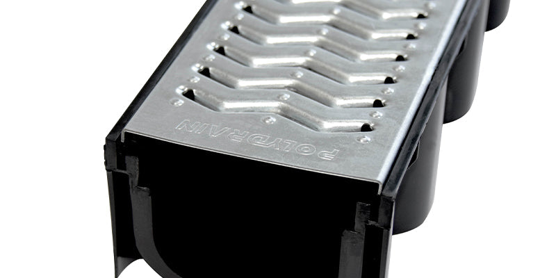 Drainage channel with galvanised slotted grate on a white background